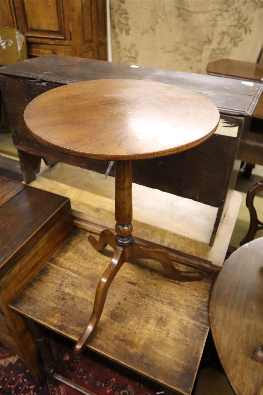 A George III circular mahogany tilt top wine table, formerly painted and later, 46cm diameter, 71cm high
